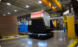 AMR system transporting pallets in manufacturing facility