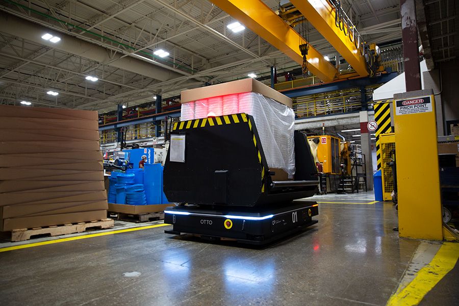 OTTO 1500 autonomous mobile robot carrying materials through a manufacturing facility at Mauser Packaging Solutions.