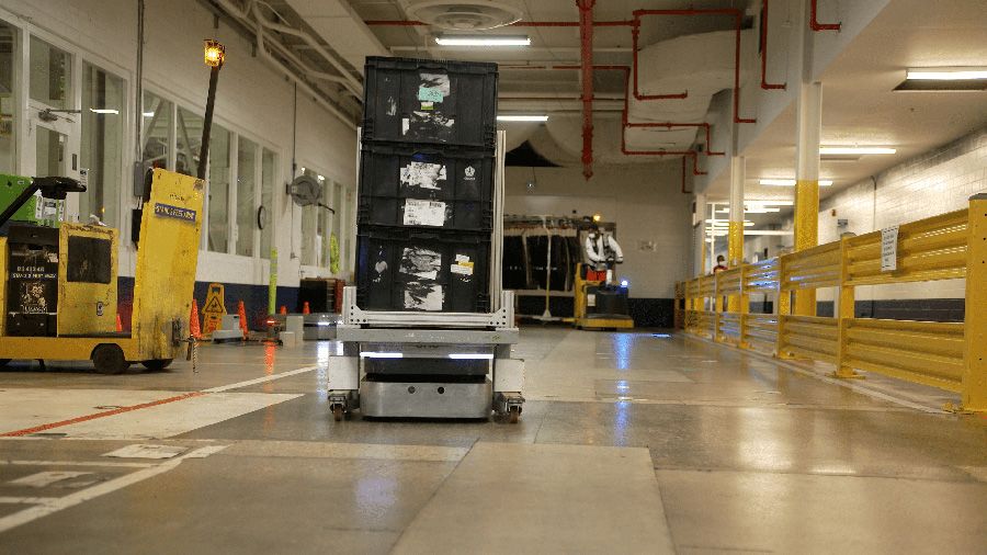 Compact OTTO 100 autonomous mobile robot operating in a constrained factory space to maximize floor efficiency.