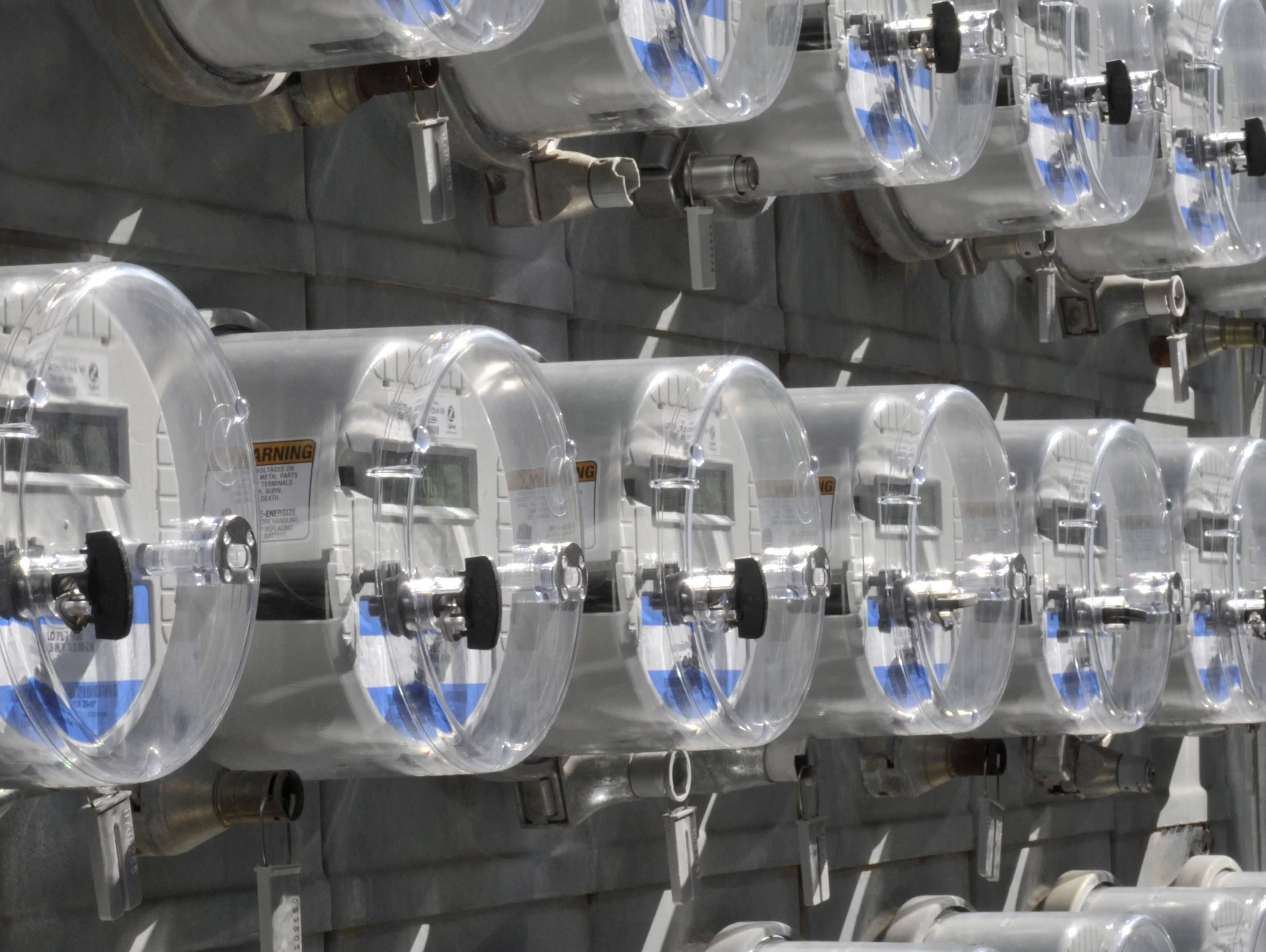 Centralized electrical meter bank installed on an exterior wall of a multifamily building